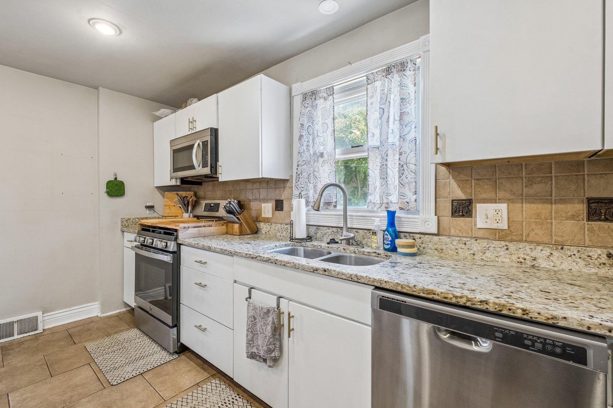 725 Hill Road Philadelphia, PA 19128 - Photo 13 of 43 a kitchen with stainless steel appliances granite countertop a sink stove and cabinets
