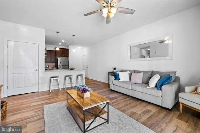 a living room with furniture and a wooden floor