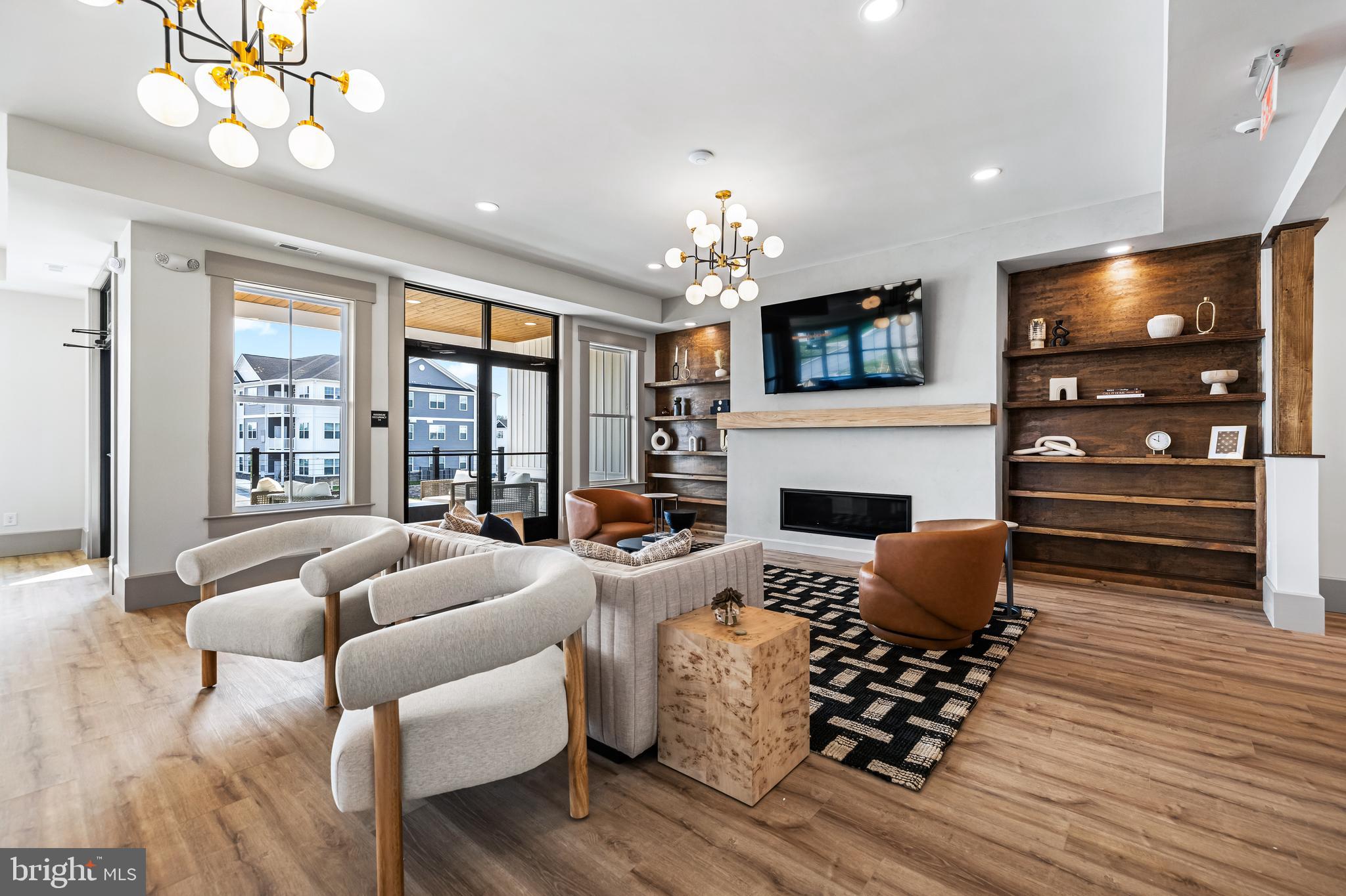 1006 Admiral Lane, Unit 203 Hanover, PA 17331 - Photo 30 of 36 a living room with furniture a fireplace and a flat screen tv