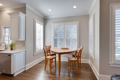 a view of a dining room with furniture and window