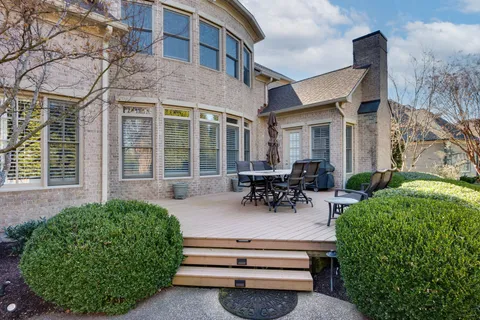 a front view of a house with a yard covered with snow