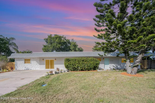 a front view of a house with a yard and a garage