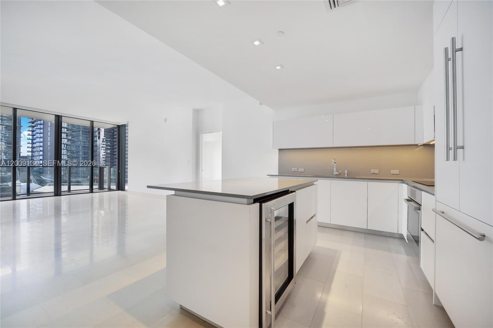 88 Southwest 7th Street, Unit 1009 Miami, FL 33130 - Photo 14 of 21 a kitchen with granite countertop a refrigerator and a sink