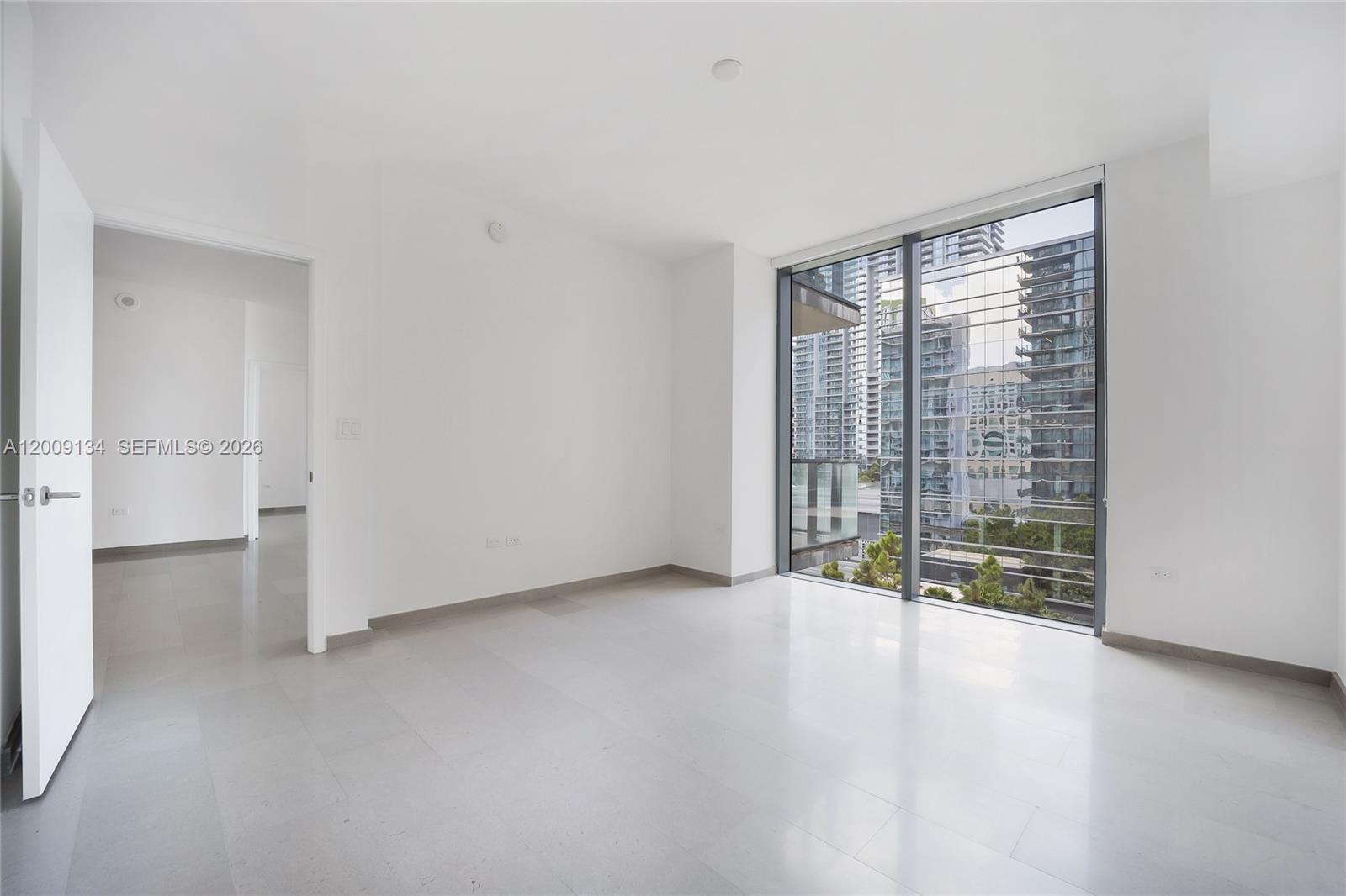 88 Southwest 7th Street, Unit 1009 Miami, FL 33130 - Photo 4 of 21 a view of an empty room with a window