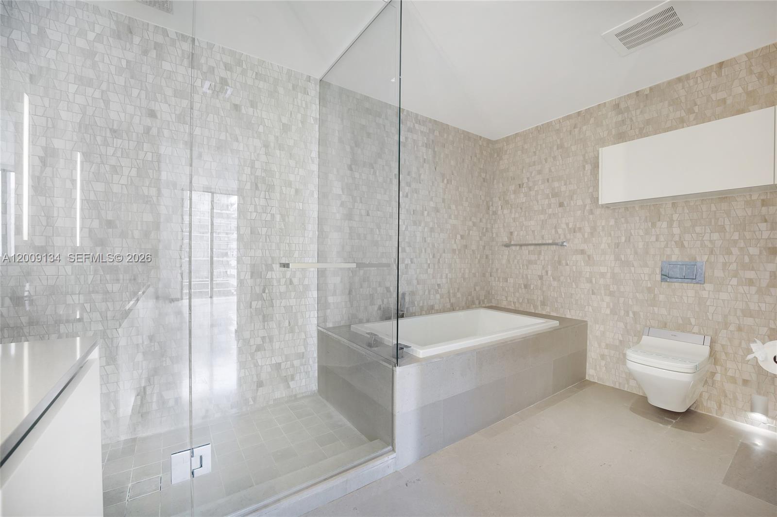 88 Southwest 7th Street, Unit 1009 Miami, FL 33130 - Photo 6 of 21 a bathroom with a sink a toilet and bathtub