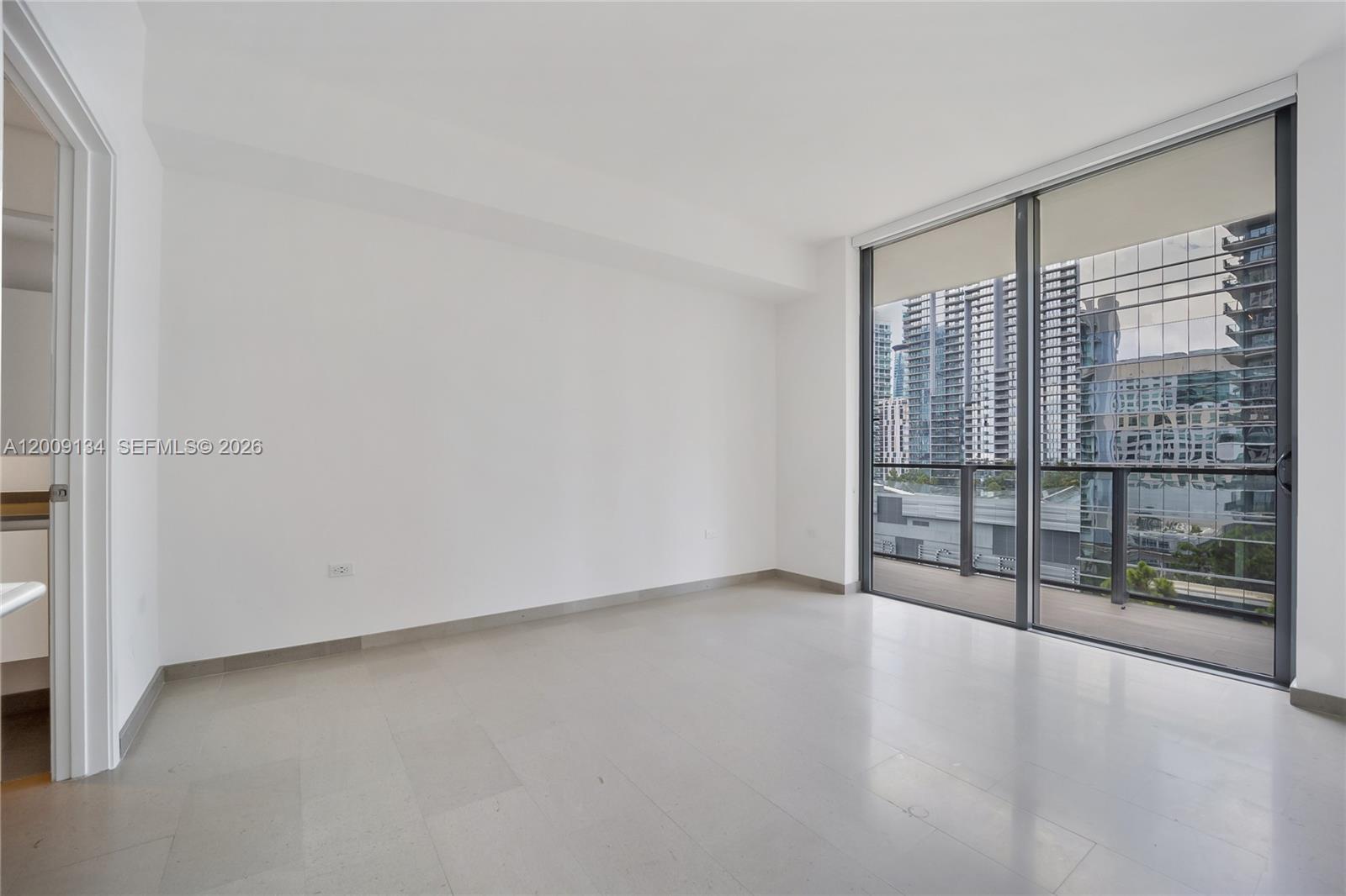 88 Southwest 7th Street, Unit 1009 Miami, FL 33130 - Photo 8 of 21 a view of an empty room with glass door