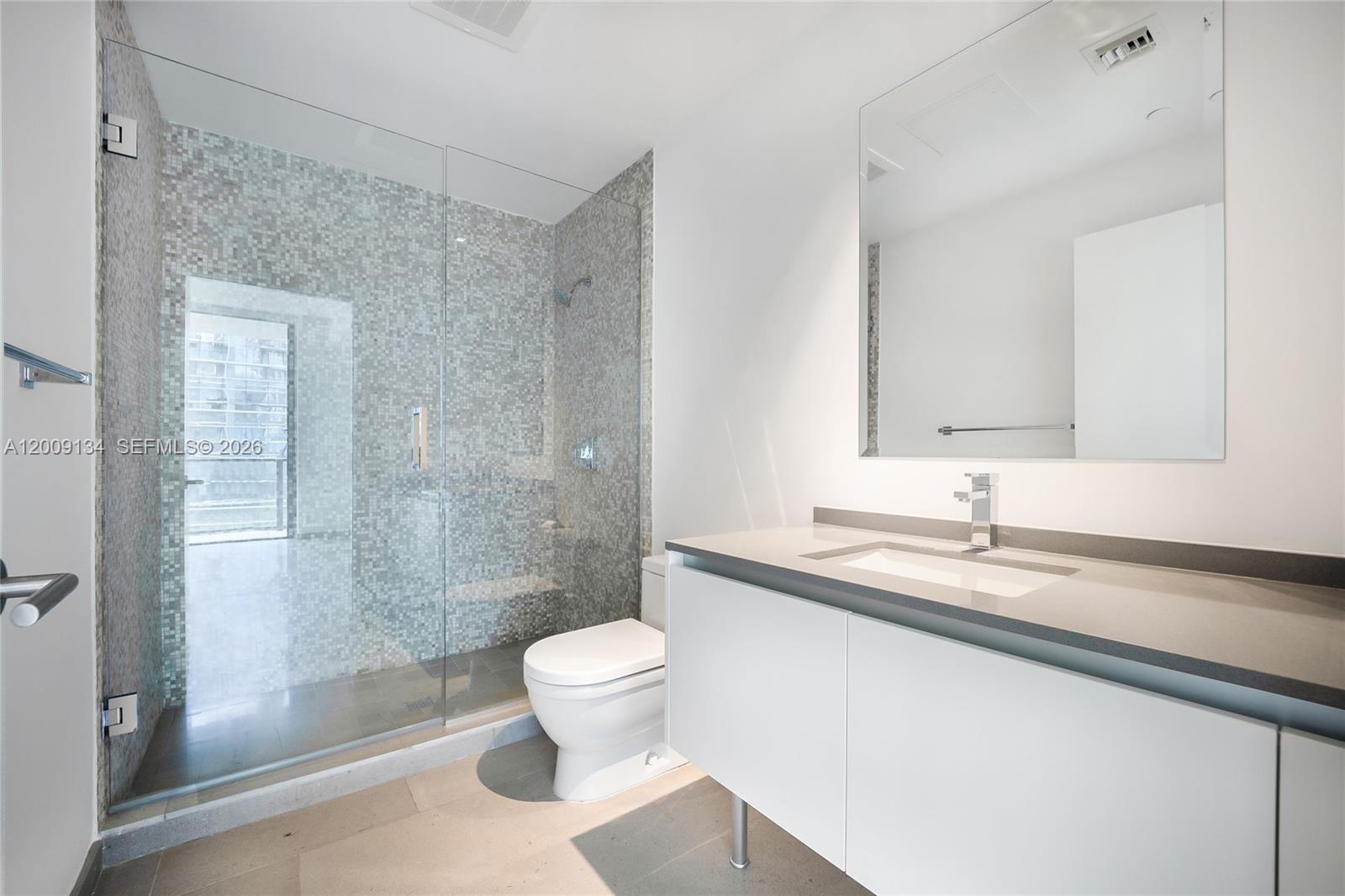 88 Southwest 7th Street, Unit 1009 Miami, FL 33130 - Photo 9 of 21 a bathroom with a sink a toilet and shower