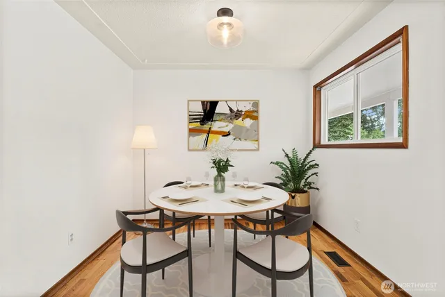 a view of a dining room with furniture and window