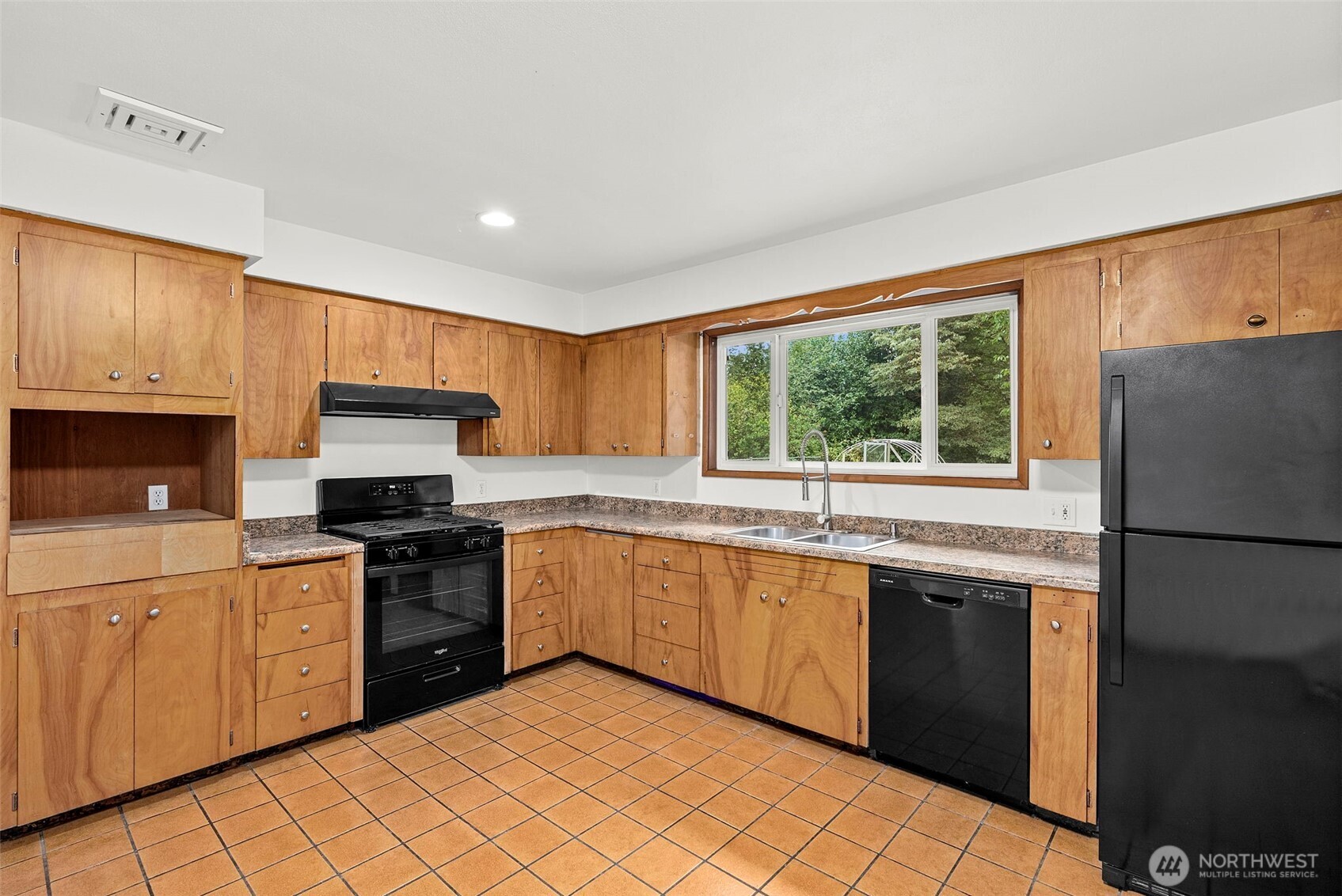 4606 15th Avenue Northeast Olympia, WA 98516 - Photo 7 of 17 a kitchen with stainless steel appliances granite countertop a stove a sink dishwasher a refrigerator and a microwave oven