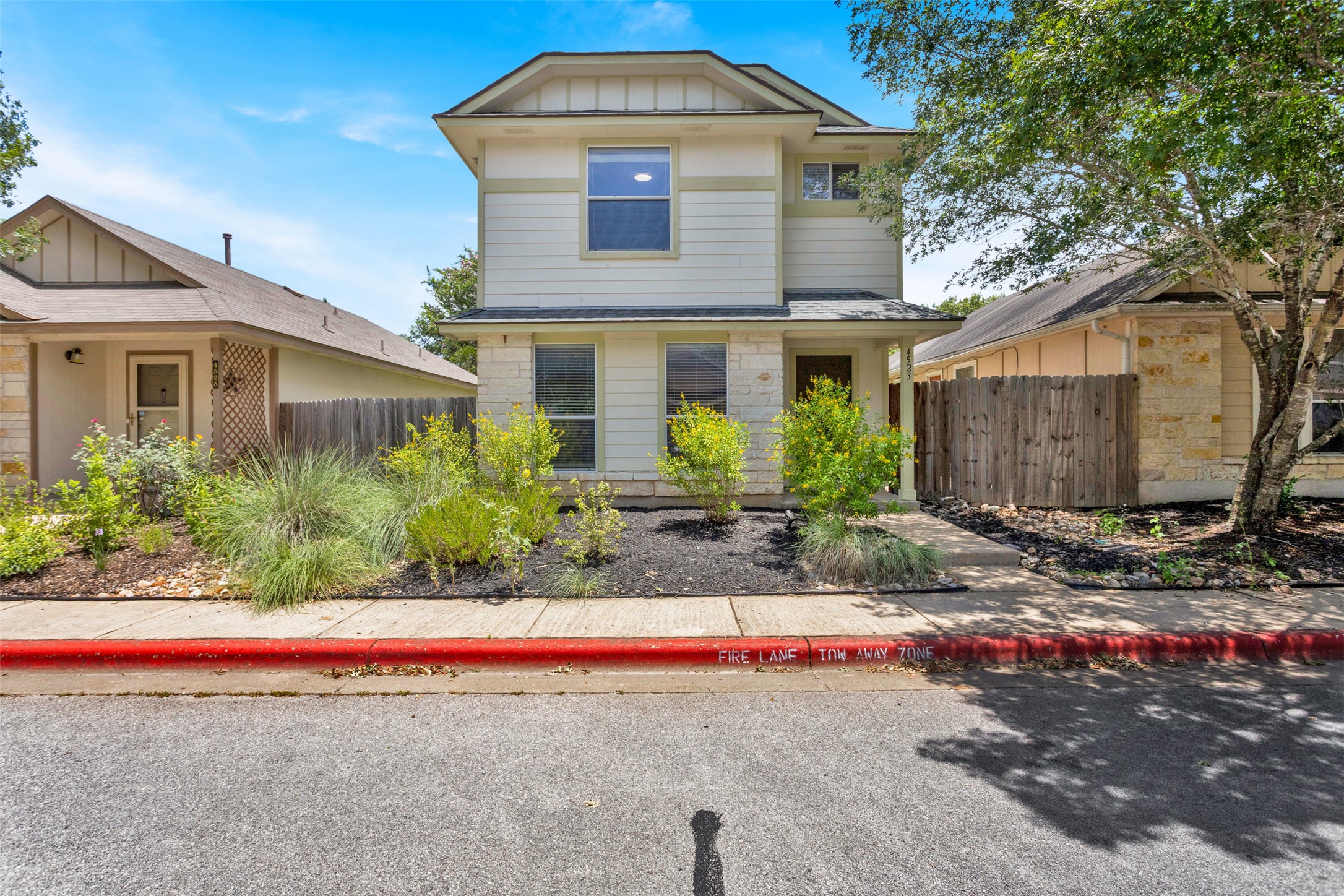 A well-maintained facade with mixed siding and stonework presents an inviting curb appeal.