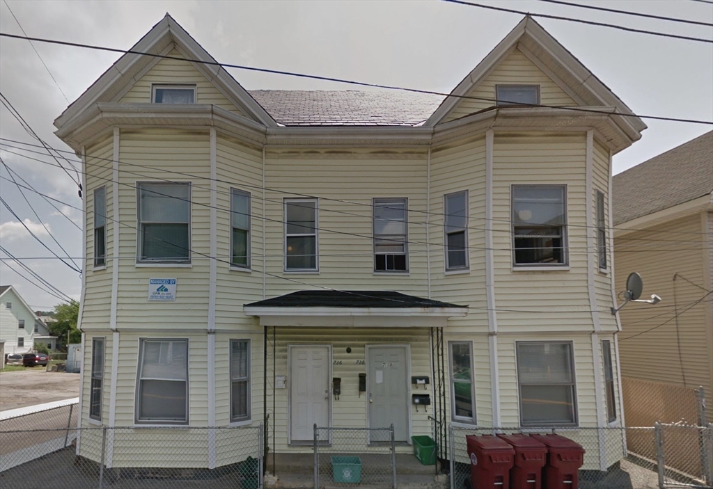 738 Central Street, Unit 2 Lowell, MA 01852 - Photo 1 of 11 a front view of a house with glass windows
