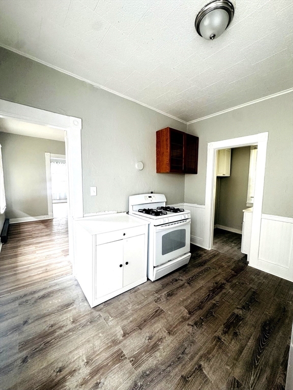 738 Central Street, Unit 2 Lowell, MA 01852 - Photo 6 of 11 a kitchen with granite countertop a stove and a sink
