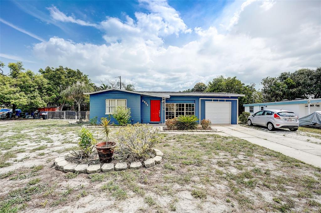 a front view of a house with a yard and seating space