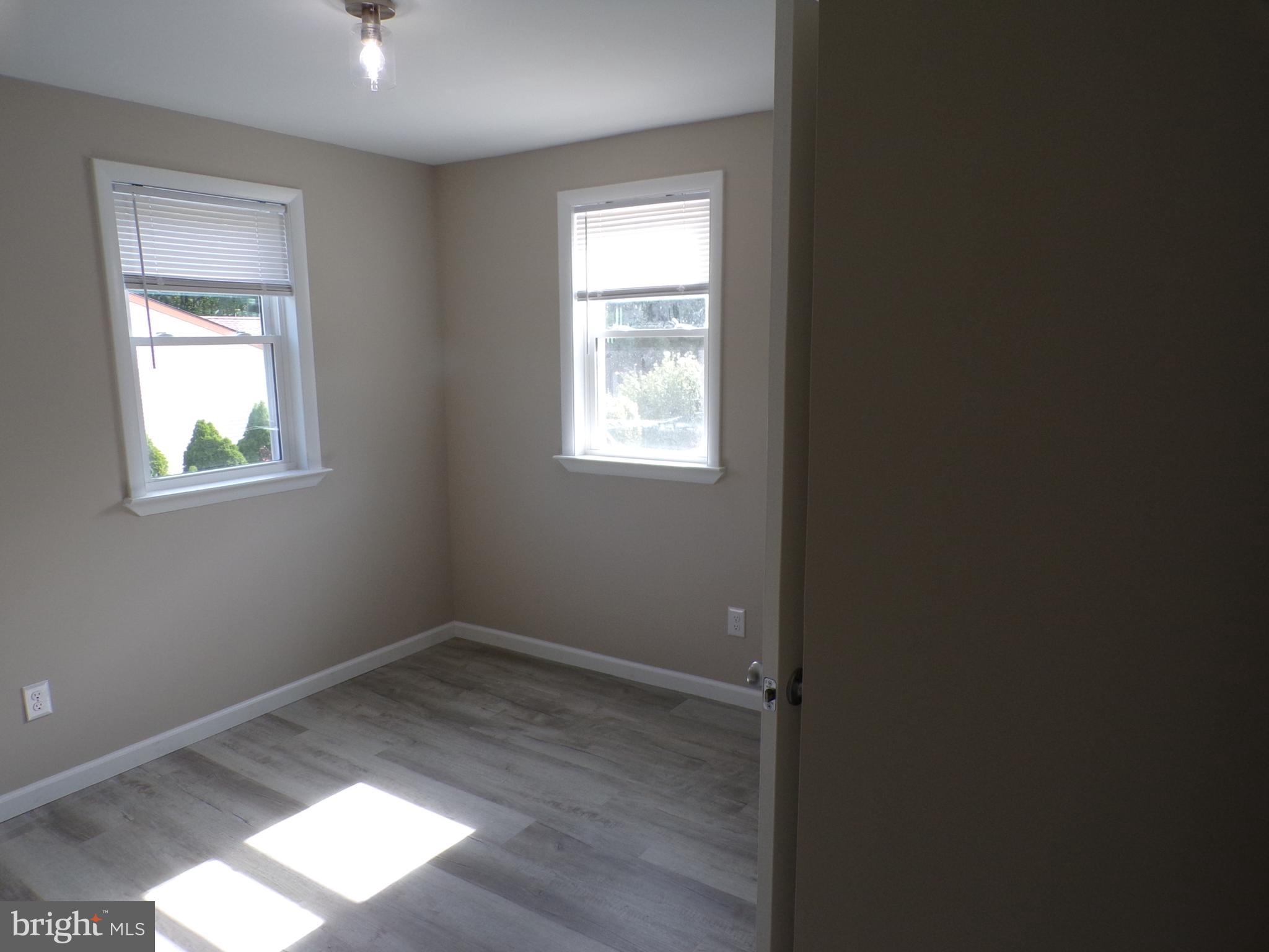 2452 Hopewell Road, Unit B Marlton, NJ 08053 - Photo 8 of 15 an empty room with wooden floor and windows