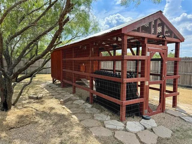 a view of a wooden bench and a window in the yard