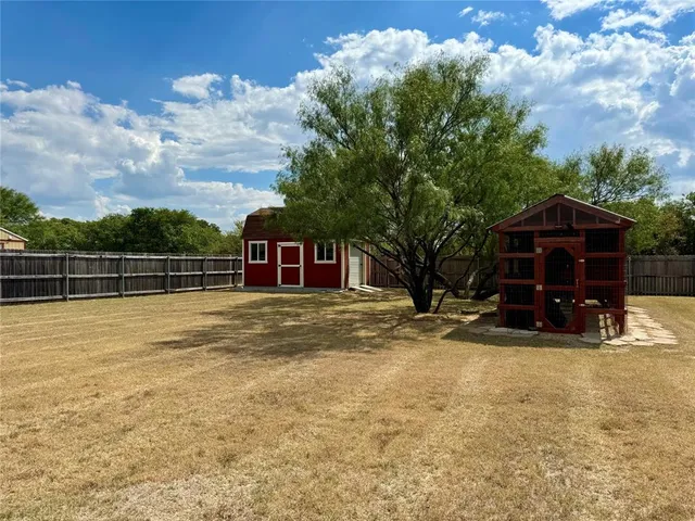 a view of a house with backyard space and balcony