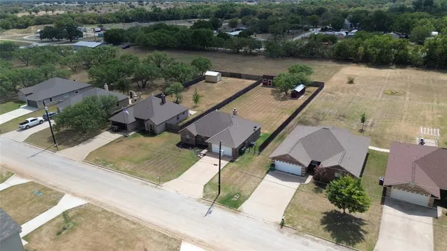 an aerial view of a house with garden space and lake view