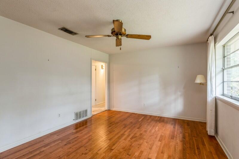 349 Powell Drive Crestview, FL 32536 - Photo 16 of 30 a view of empty room with wooden floor and fan