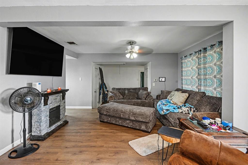 6694 Hutcheson Hill Road Springtown, TX 76082 - Photo 7 of 37 a living room with furniture and a flat screen tv