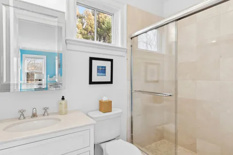 a bathroom with a sink toilet and shower