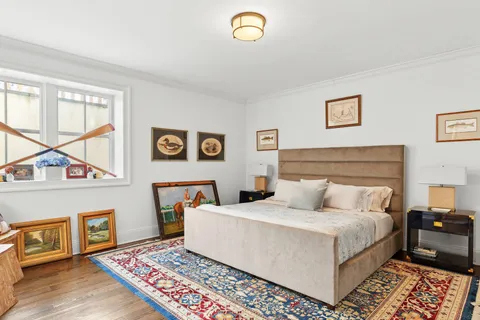 a bedroom with a bed and a lamp on dresser