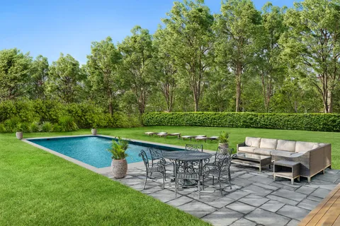 an outdoor sitting area with chairs and a table