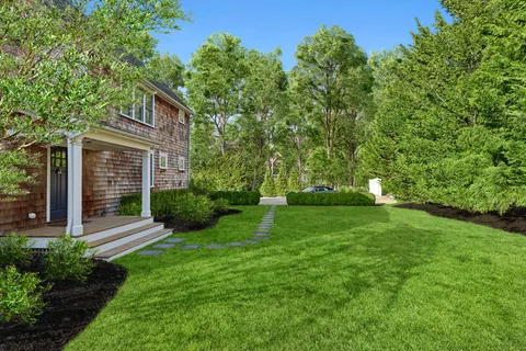 a view of a house with yard and a garden