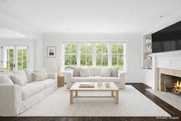 a dining room with furniture window and wooden floor