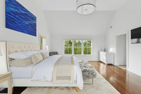 a bedroom with a bed and a chandelier