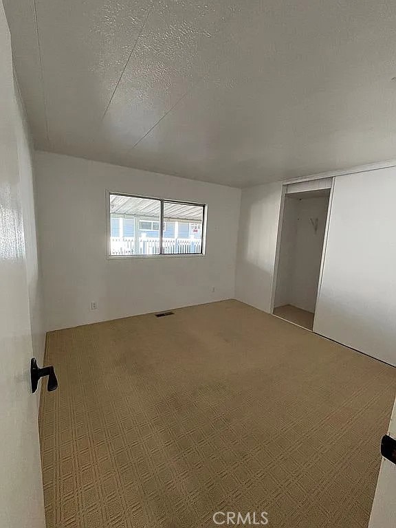 14851 Jeffrey Road, Unit 135 Irvine, CA 92618 - Photo 15 of 17 a view of an empty room with windows