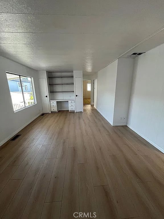 14851 Jeffrey Road, Unit 135 Irvine, CA 92618 - Photo 6 of 17 wooden floor in an empty room with a window