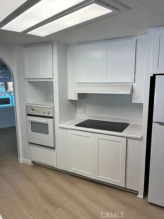 14851 Jeffrey Road, Unit 135 Irvine, CA 92618 - Photo 8 of 17 a kitchen with granite countertop white cabinets and a stove