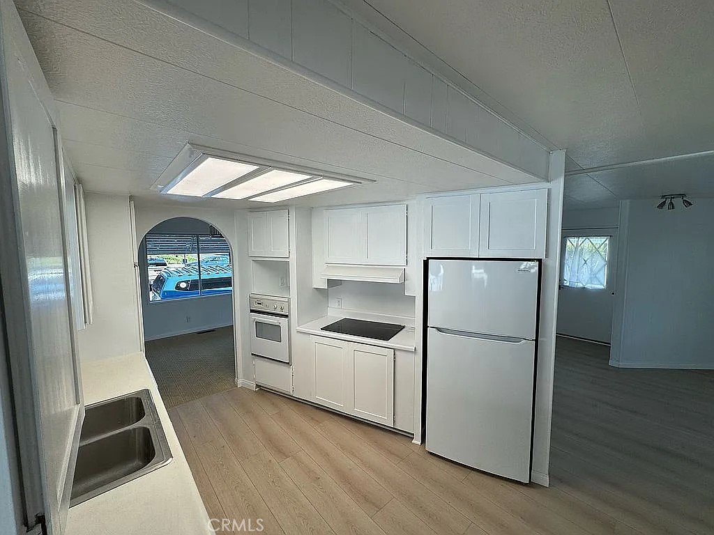 14851 Jeffrey Road, Unit 135 Irvine, CA 92618 - Photo 10 of 17 a kitchen with a refrigerator a sink and dishwasher