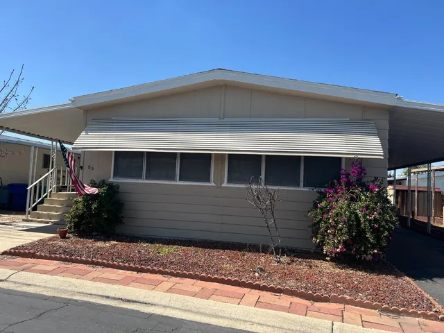 a front view of a house with a yard and a garage