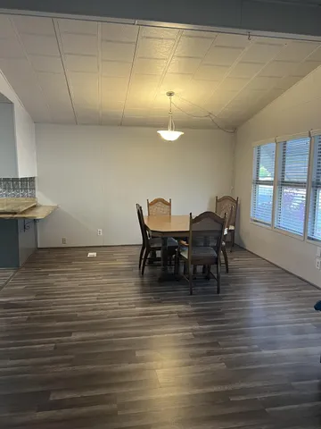 a view of a dining room with furniture and chandelier