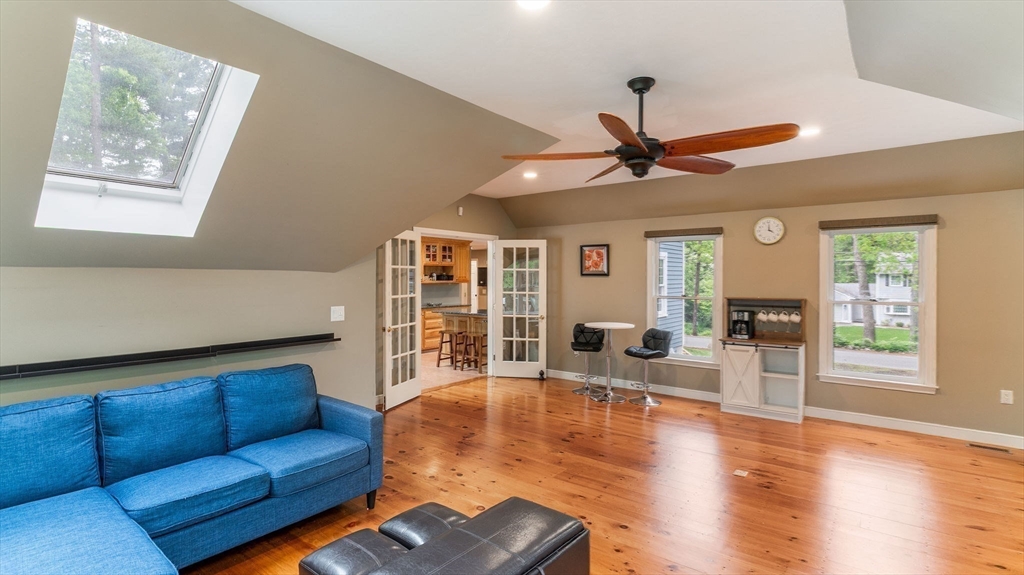 142 Baker Street Walpole, MA 02081 - Photo 17 of 42 a living room with furniture ceiling fan and a window