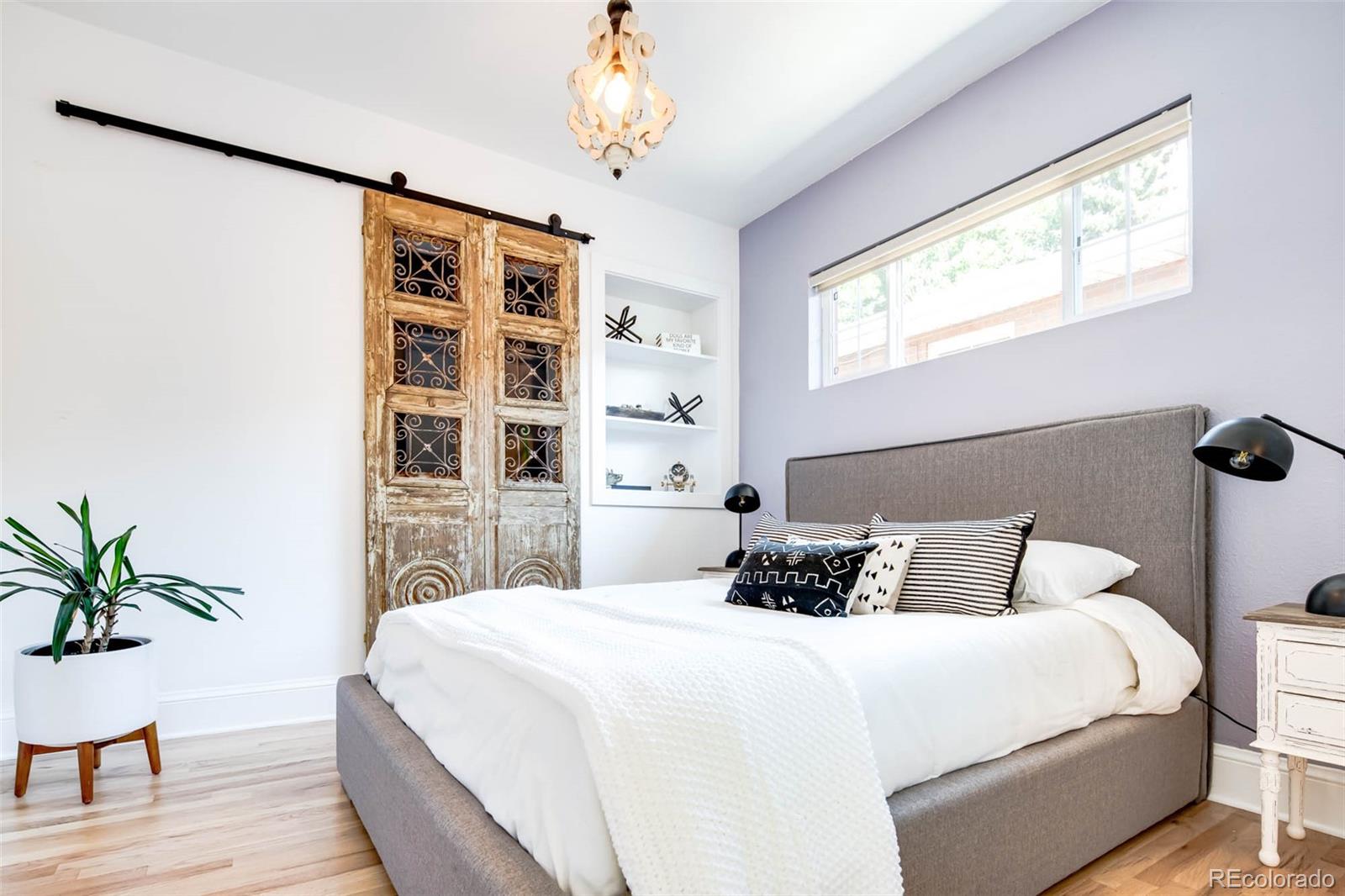 3751 Raleigh Street Denver, CO 80212 - Photo 11 of 36 a bedroom with a large bed and a potted plant