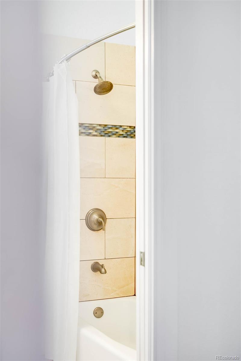 3751 Raleigh Street Denver, CO 80212 - Photo 14 of 36 a bathroom with a shower and mirror