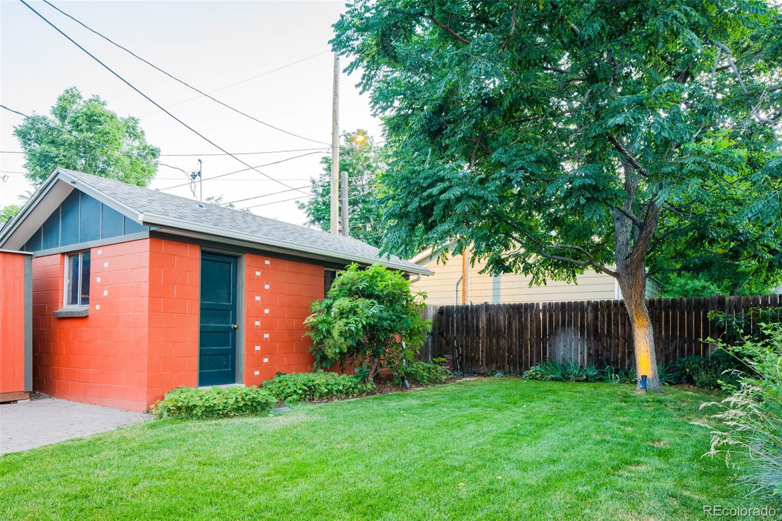 3751 Raleigh Street Denver, CO 80212 - Photo 18 of 36 a view of a backyard with plants and large trees