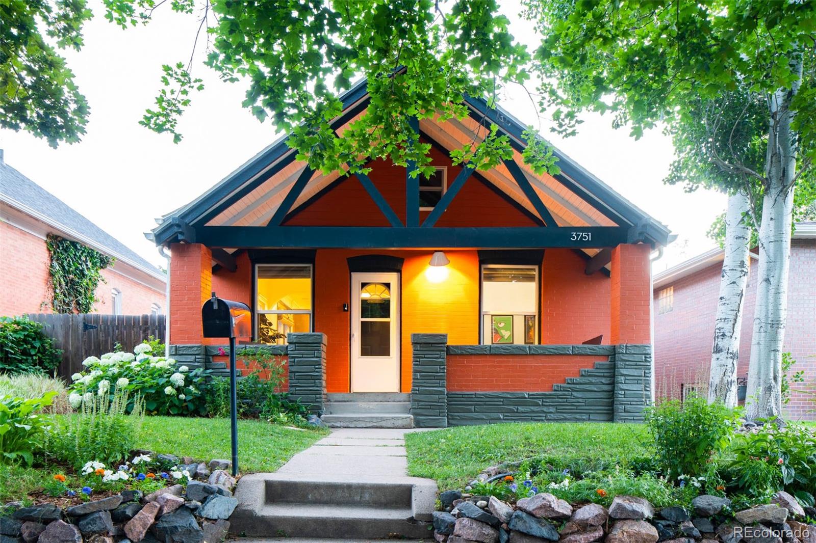 3751 Raleigh Street Denver, CO 80212 - Photo 20 of 36 a front view of a house with garden