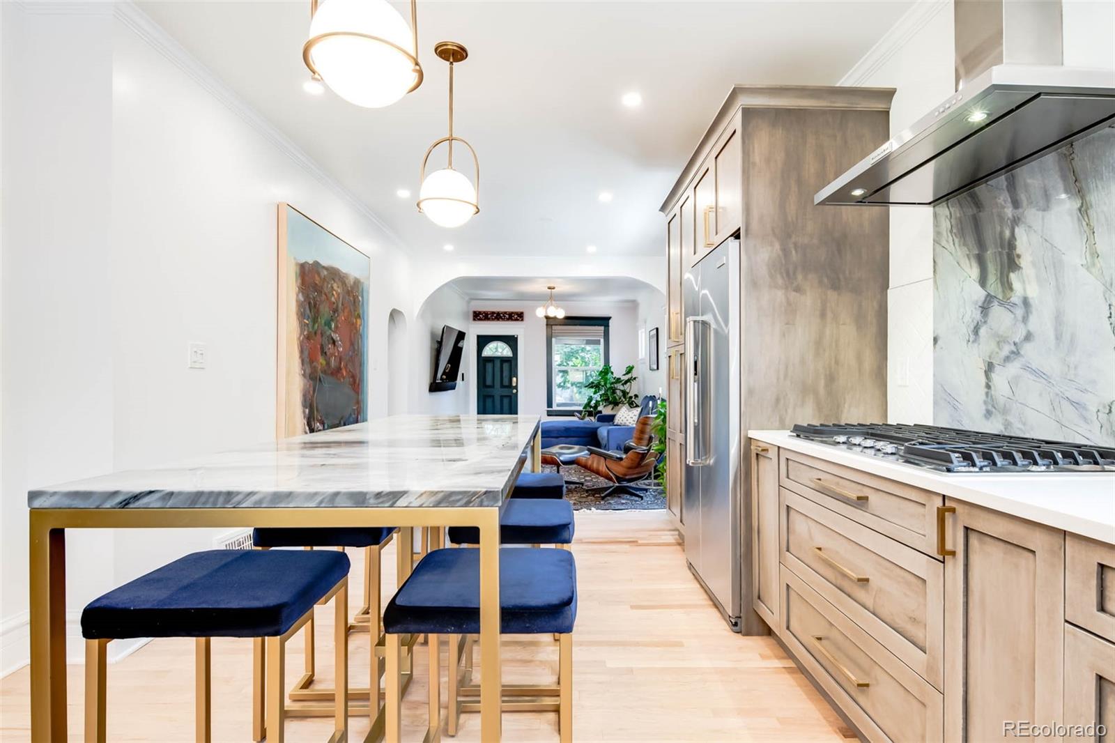 3751 Raleigh Street Denver, CO 80212 - Photo 9 of 36 a kitchen with stainless steel appliances granite countertop a stove and cabinets