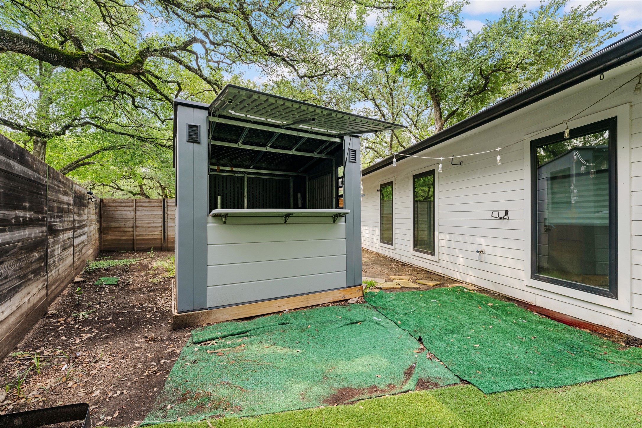 8900 Point W Drive Austin, TX 78759 - Photo 36 of 40 An inviting backyard oasis awaits with a modern outdoor bar structure.