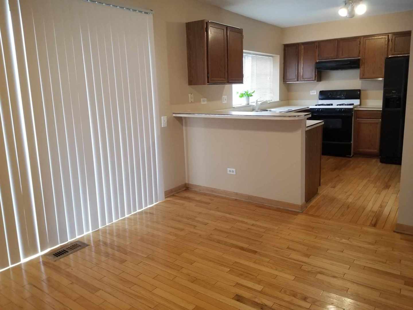 7 North Oltendorf Road Streamwood, IL 60107 - Photo 12 of 31 a kitchen with stainless steel appliances granite countertop a stove a sink and a refrigerator