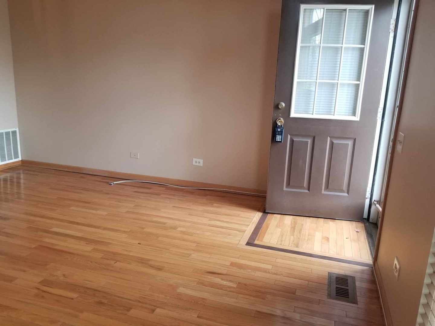 7 North Oltendorf Road Streamwood, IL 60107 - Photo 4 of 31 an empty room with wooden floor and windows