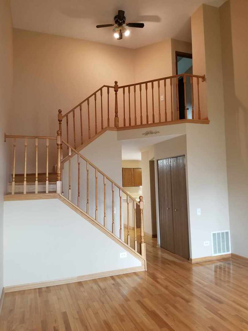 7 North Oltendorf Road Streamwood, IL 60107 - Photo 6 of 31 a view of staircase with railing and a chandelier