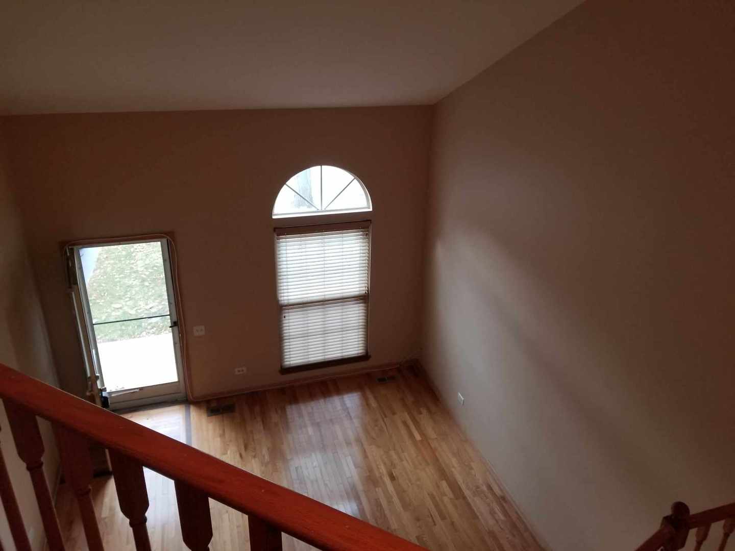 7 North Oltendorf Road Streamwood, IL 60107 - Photo 9 of 31 an empty room with wooden floor and windows
