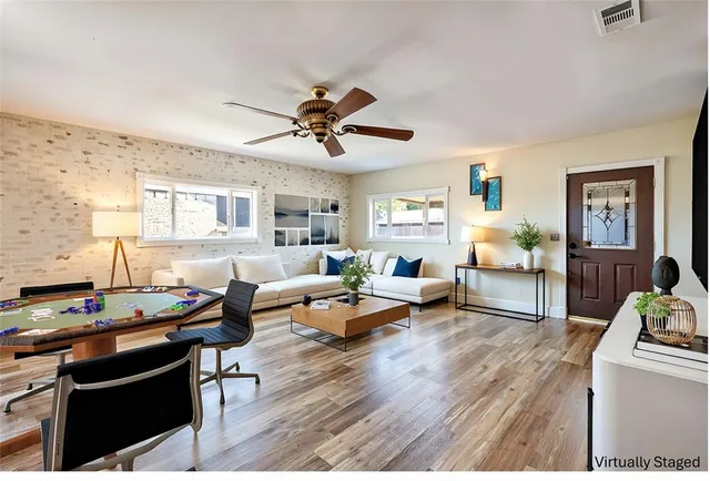 a living room with furniture and wooden floor