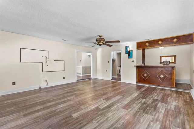 a view of a room with wooden floor