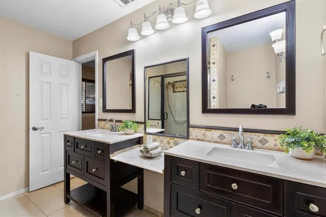 a bathroom with a sink double vanity and a mirror
