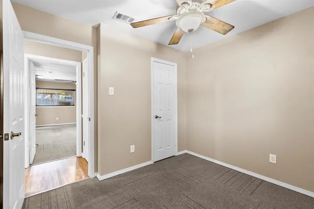 a view of an empty room with a mirror